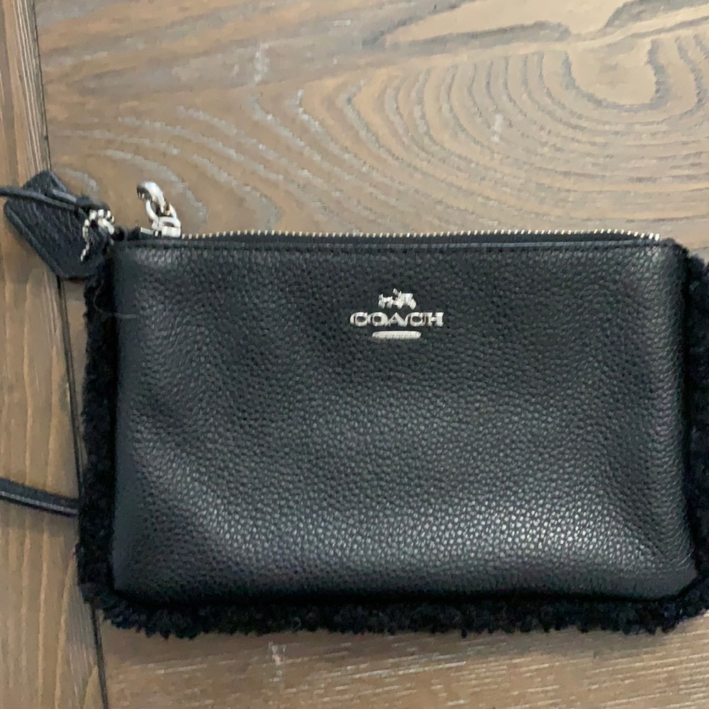 Black leather coach wristlet with fur border